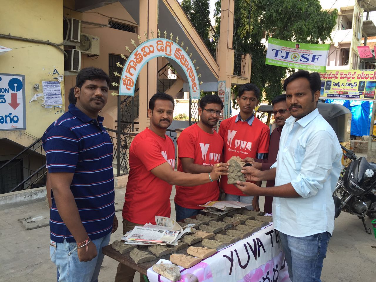 Volunteers planting trees in a park as part of a Go Green initiative.